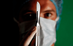 The surgeon is preparing for surgery to increase members